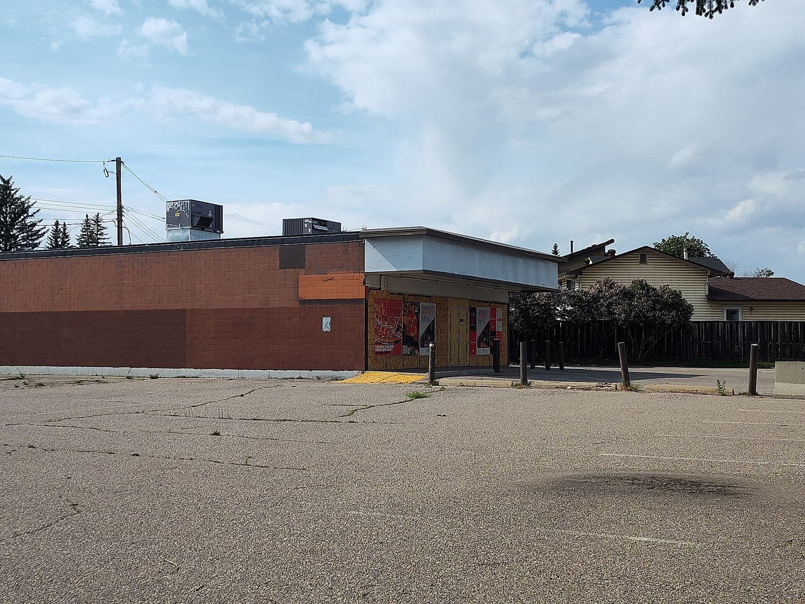 An abandoned 7-Eleven store with its signage still mounted, closed and empty, in the Ogden community of Calgary
