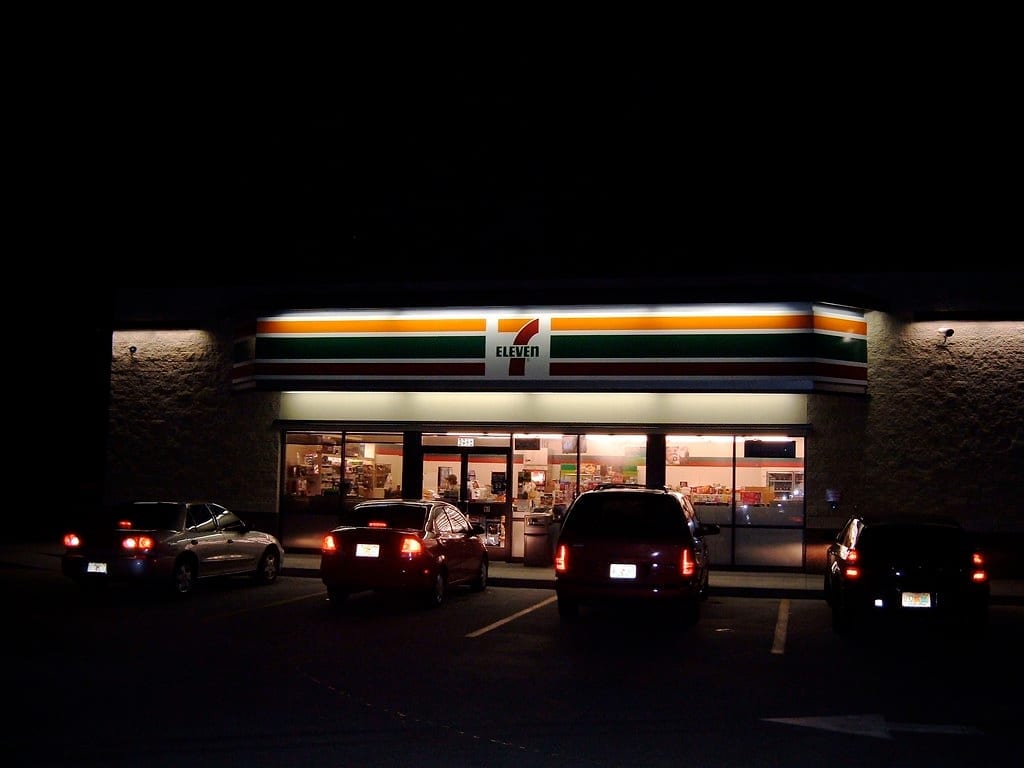 7-Eleven branded fuel pumps and canopy signage at a combined gas station and convenience store.
