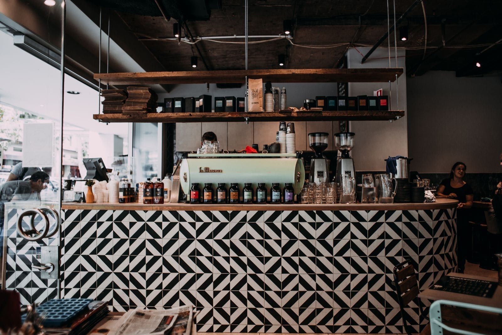 Staff working behind a service counter in a fast-casual restaurant interior