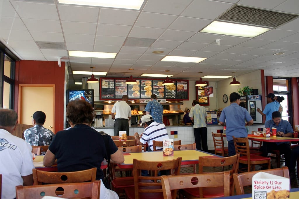 Popeyes restaurant interior with the front counter and menu boards visible