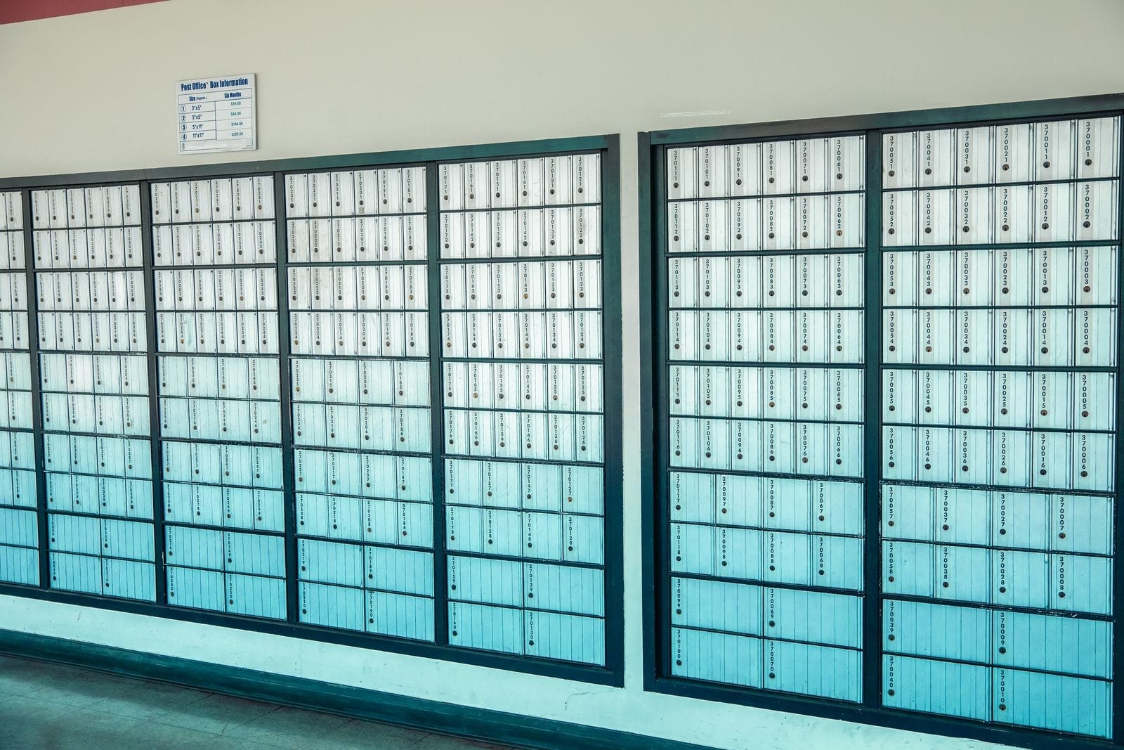 Rows of numbered private mailboxes lining a wall inside a shipping and postal services store