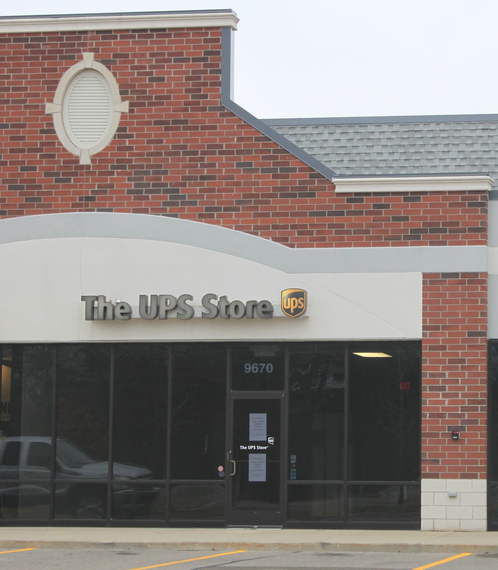The UPS Store storefront with signage in a Pinckney, Michigan retail plaza